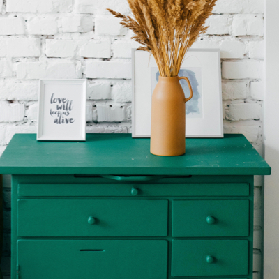 green dressing table with a gold plant pot